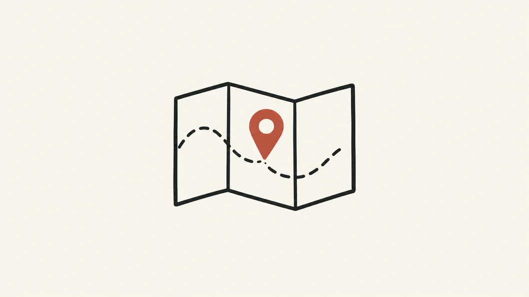 Folded map with a rust location pin and a dotted route